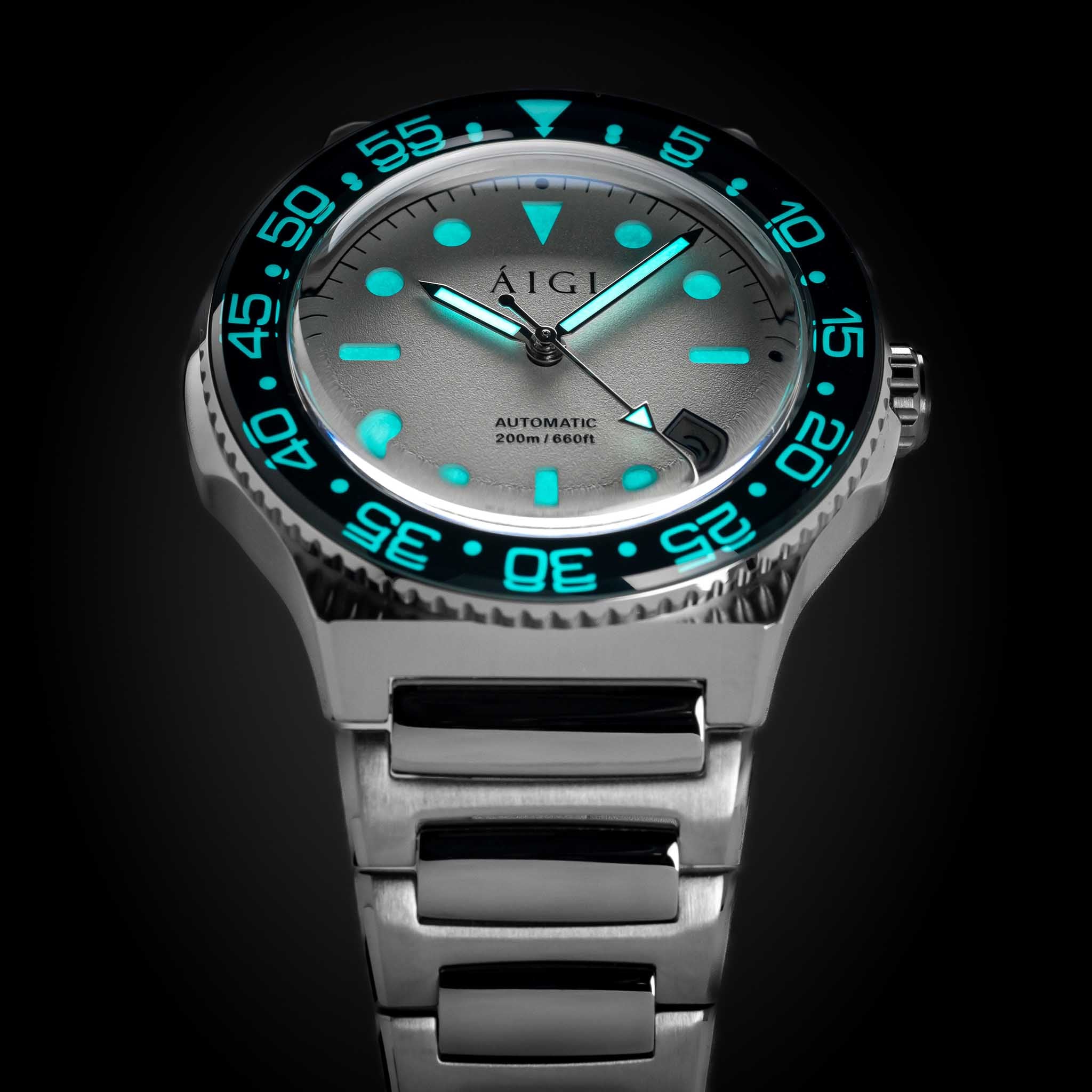AIGI Arctic Diver automatic watch with white dial glowing lume in low light.